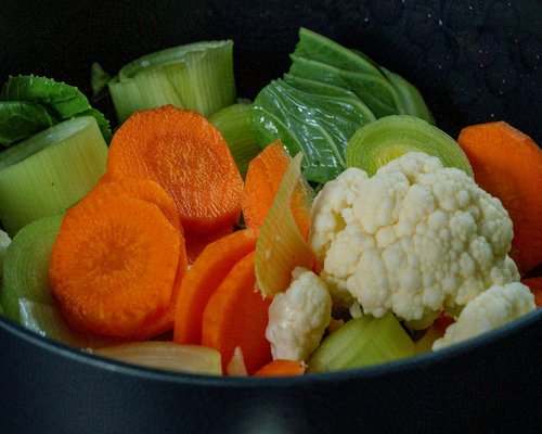 Bowl of fresh nutritious vegetables and fruits illustrating balanced diet and wholesome meals